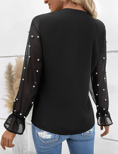 Blouse élégante avec manches transparentes et perles