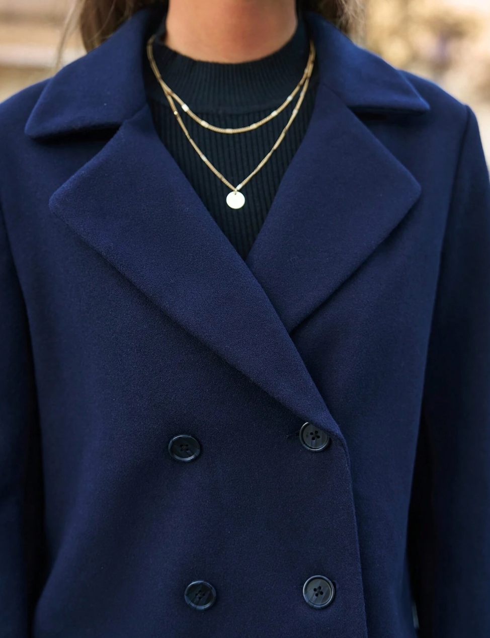 Manteau avec revers et double patte de boutonnage